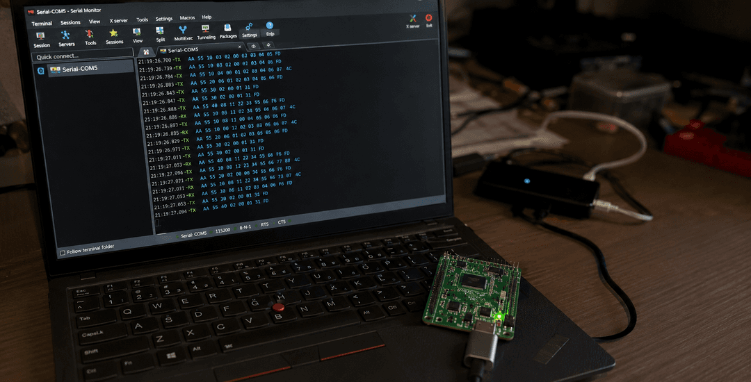 Messy tech workstation with serial monitor