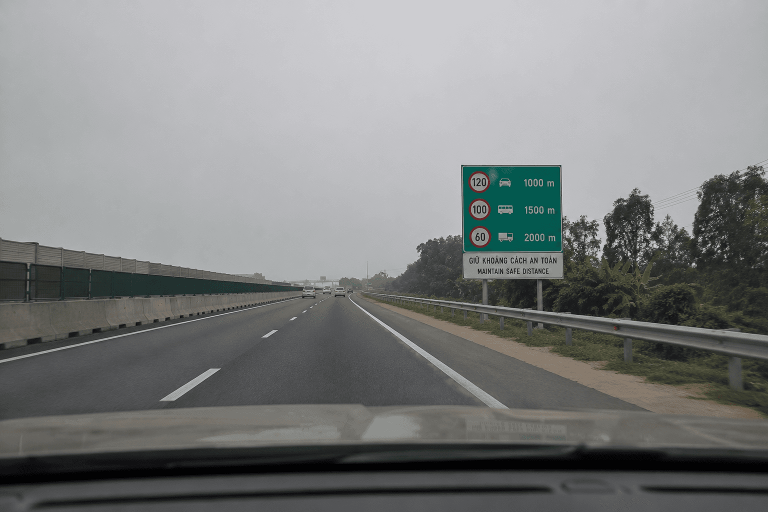 Highway drive with road sign and trees